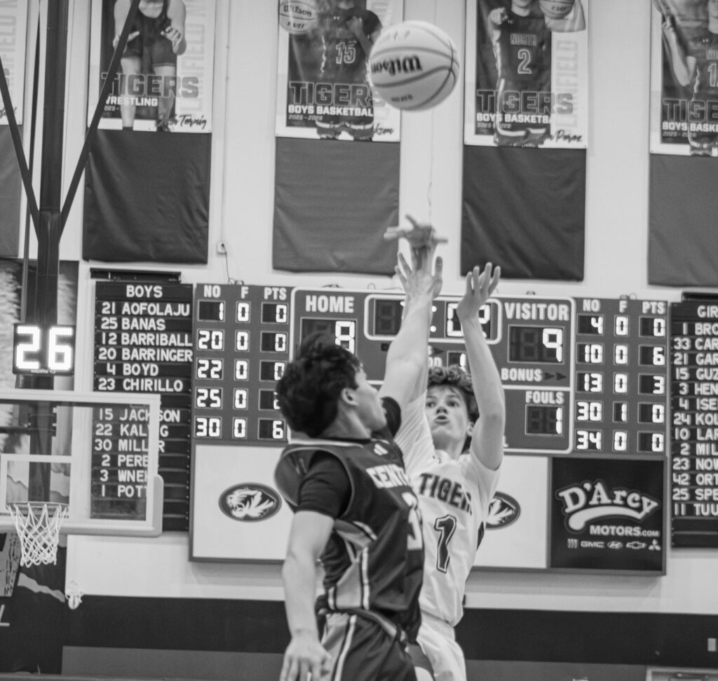 Battle between Plainfield North High School and rivalry school, Plainfield Central, at basketball game. Photo Credit: Christian Roman.