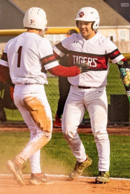 Junior Catcher Connor Eydenburg celebrating an RBI with Senior Ryan Potter (number 1). Photo by Piton Media
