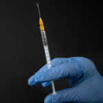 Person holding vaccine. Phone Credit. unsplash